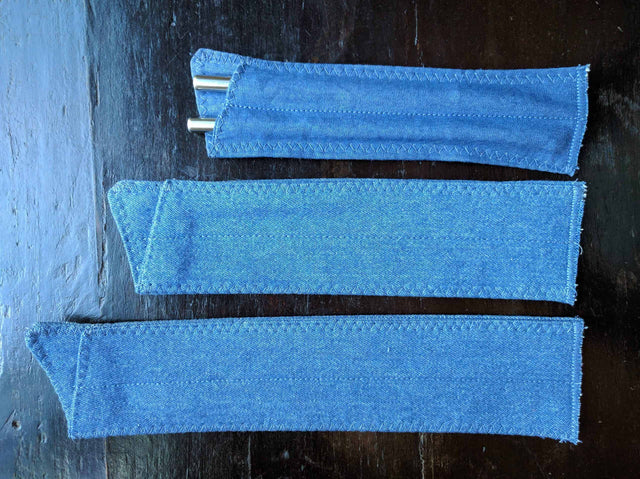 Three denim straw pouches shown in different lengths with stainless steel straws