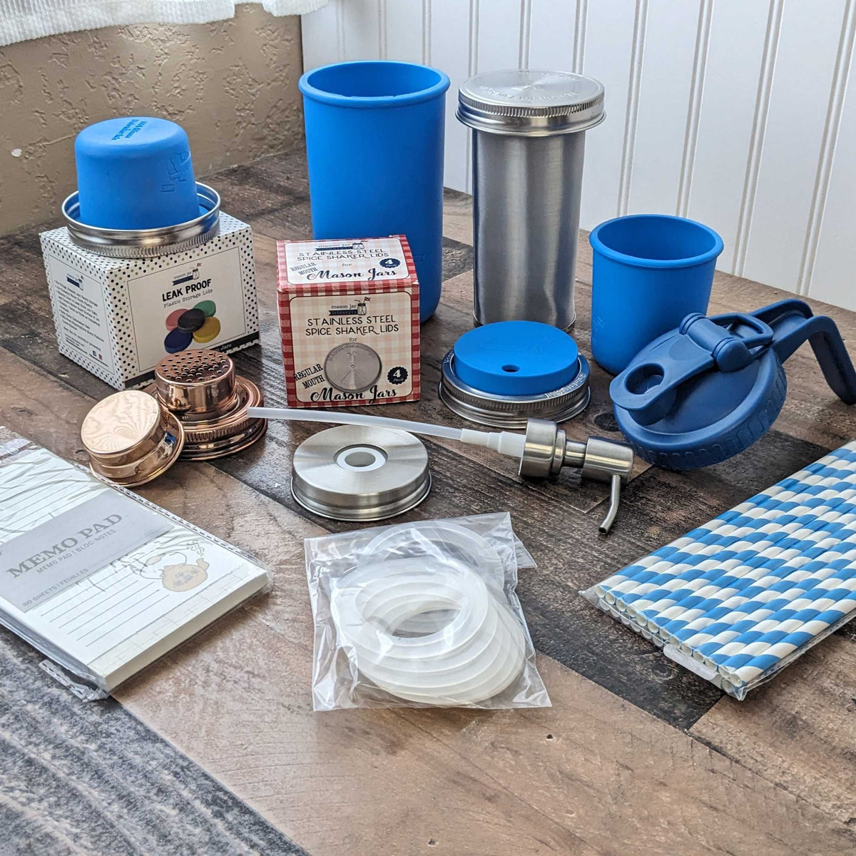 Assortment of Mason Jar Lifestyle products and packaging displayed on a picnic blanket