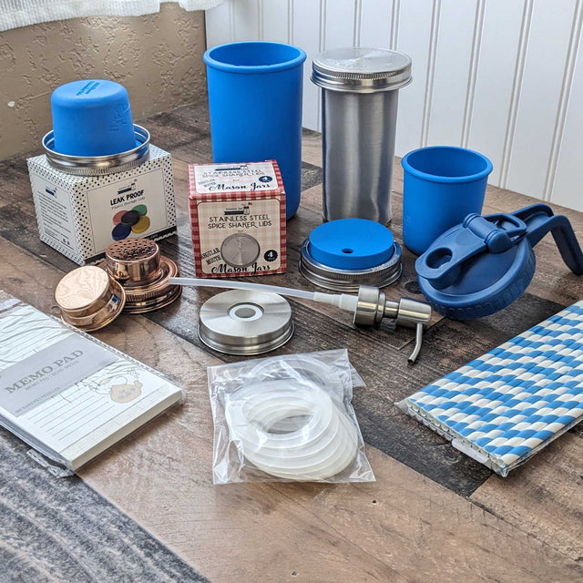 Assortment of Mason Jar Lifestyle products and packaging displayed on a picnic blanket