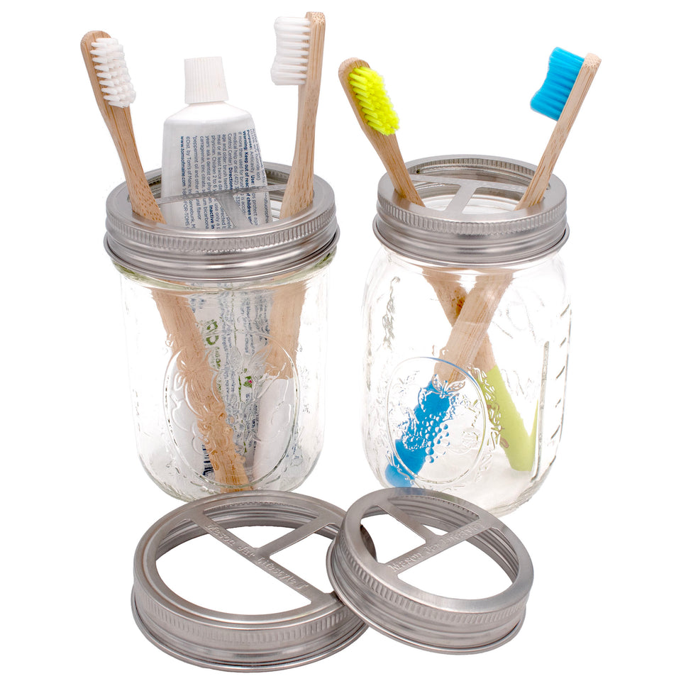 Stainless steel toothbrush holder lid for both regular mouth and wide mouth Mason jars on a 16oz jar.