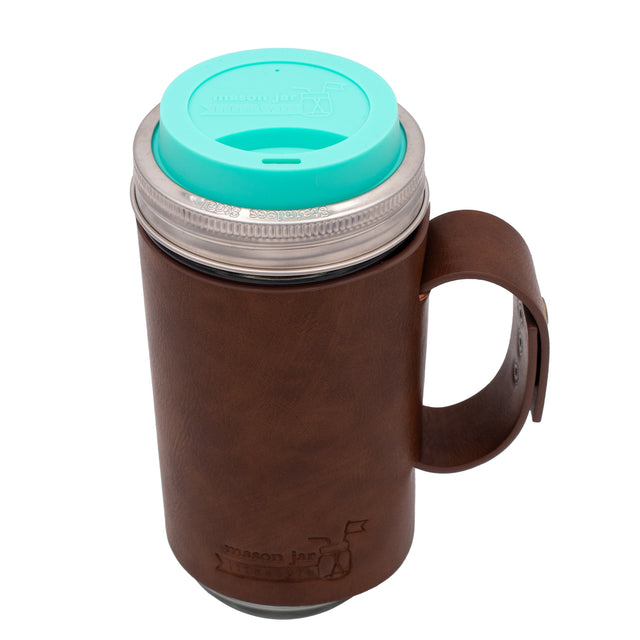 24oz glass Mason jar travel mug with brown faux leather handle sleeve, Aquamarine silicone drinking lid, and stainless steel band