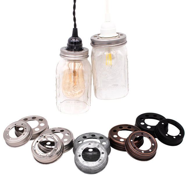 Lighting lids in wide and regular mouth sizes: stainless steel, mirror, galvanized, oil rubbed bronze, and black. These are in front of two open bottom mason jars with pendant wiring.