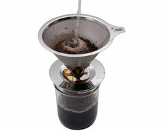 Stainless steel pour-over coffee filter brewing coffee into a Wide Mouth Mason jar.