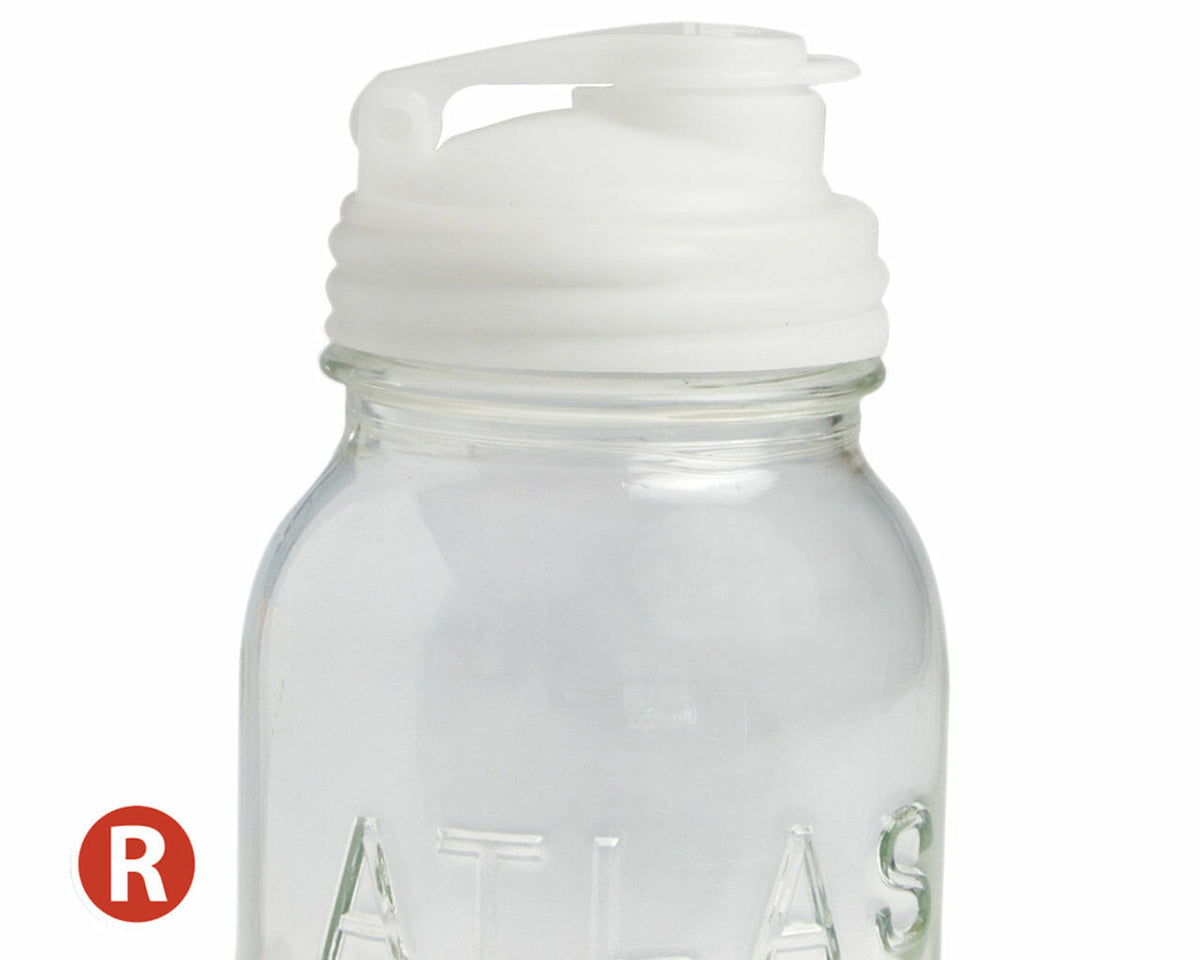Natural Regular Mouth reCAP pour spout lid closed on a Mason jar.
